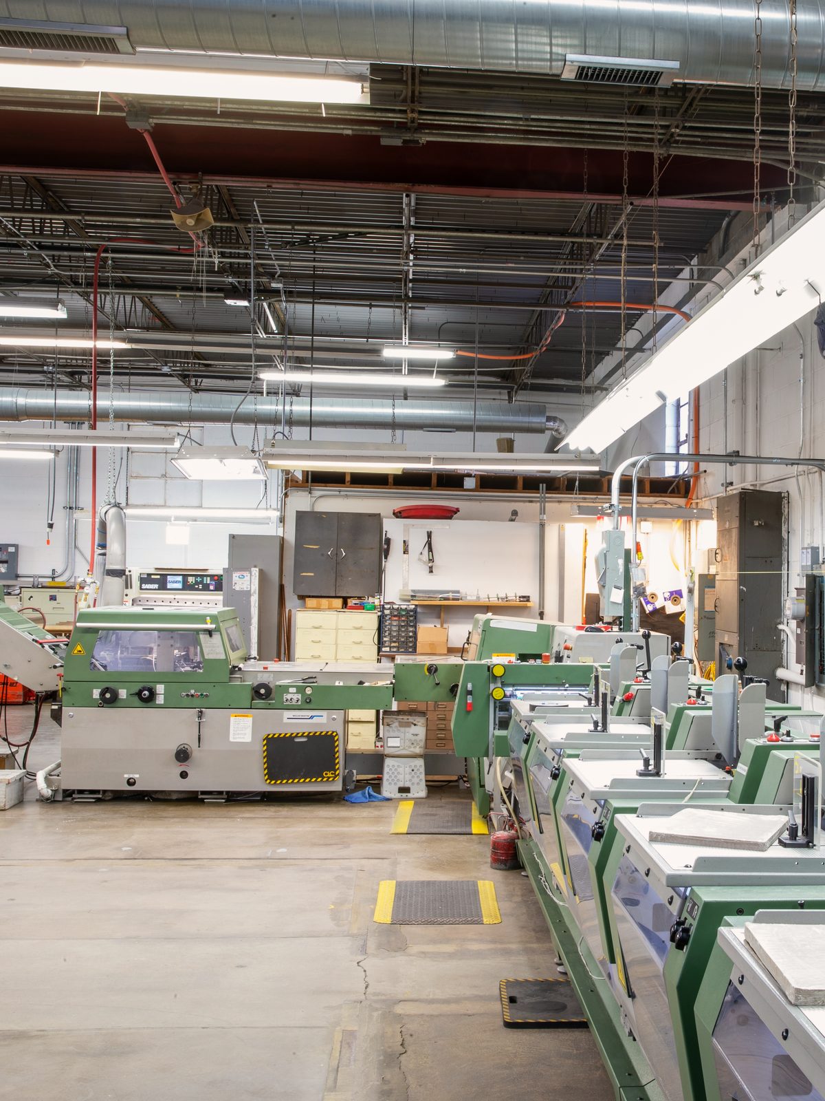 Müller Martini bindery line at Bell Litho, Inc., where benefits booklets are gathered and stitched