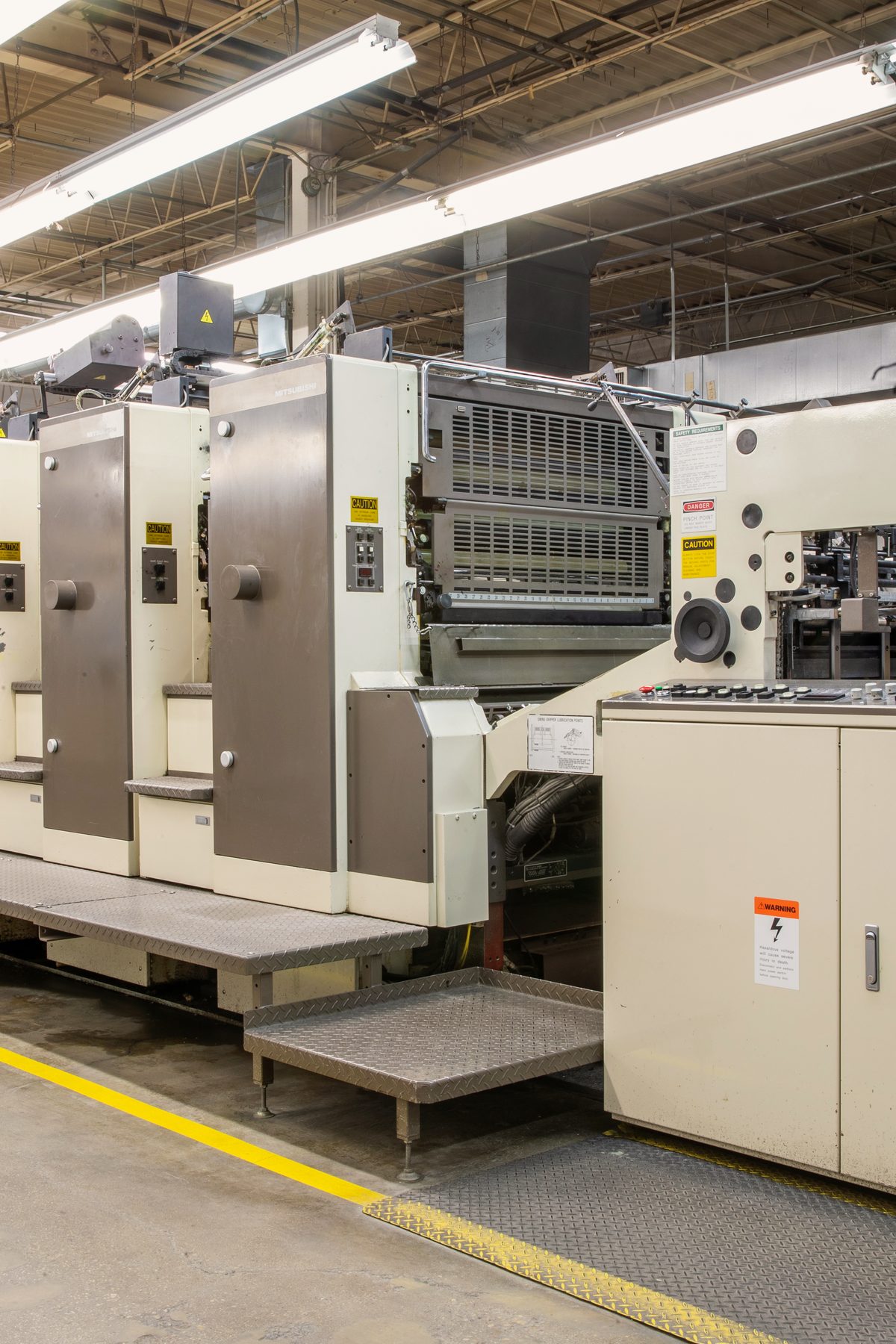 Six-color Mitsubishi sheetfed offset press line at Bell Litho, Inc., where cut-and-stack label work is printed